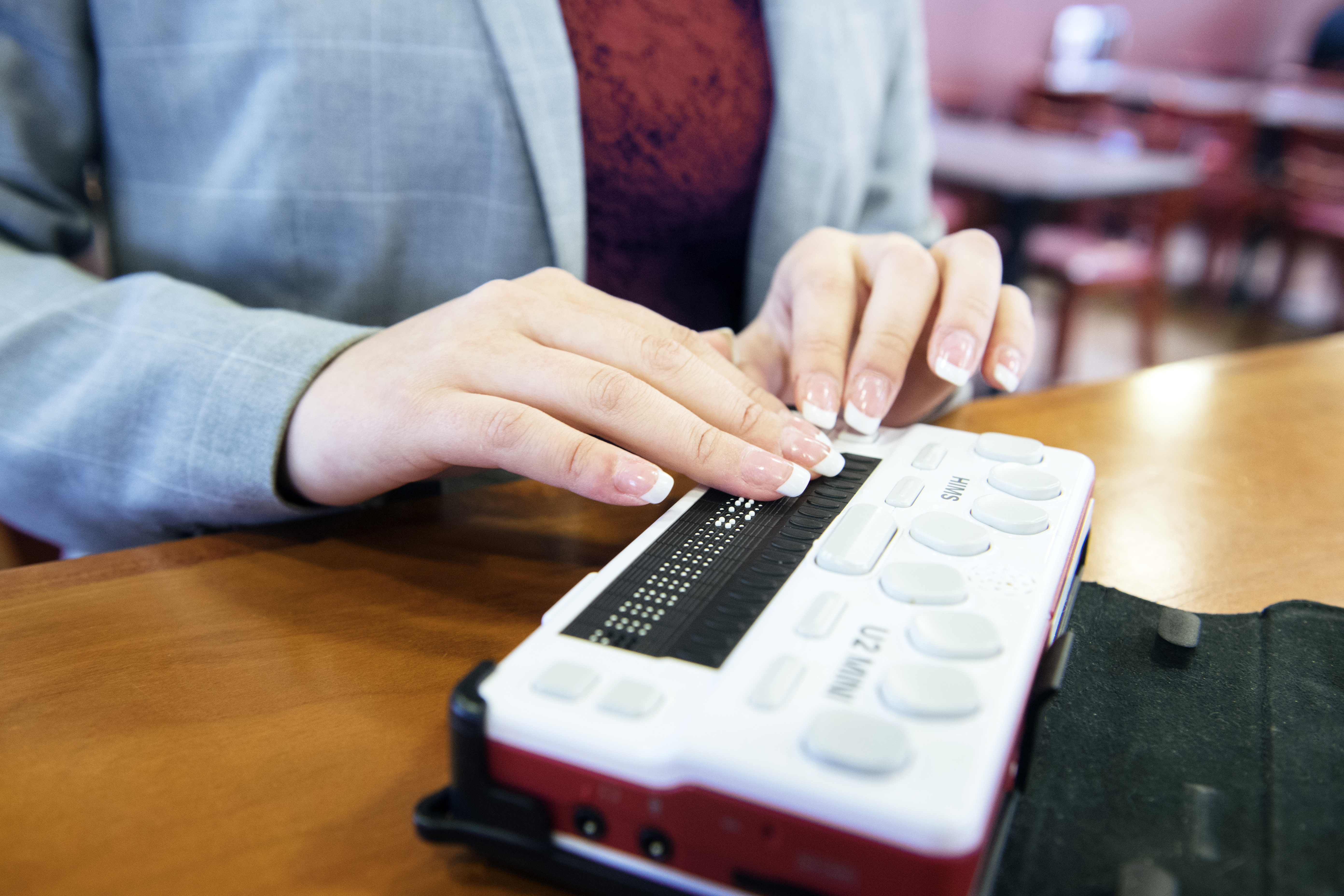 Individual using a braille reader