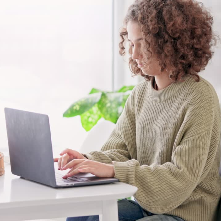 Young female sitting at a desk working on a computer