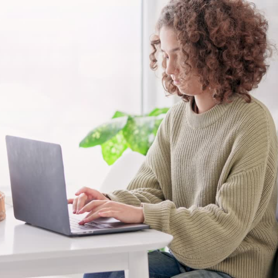 Young female sitting at a desk working on a computer 