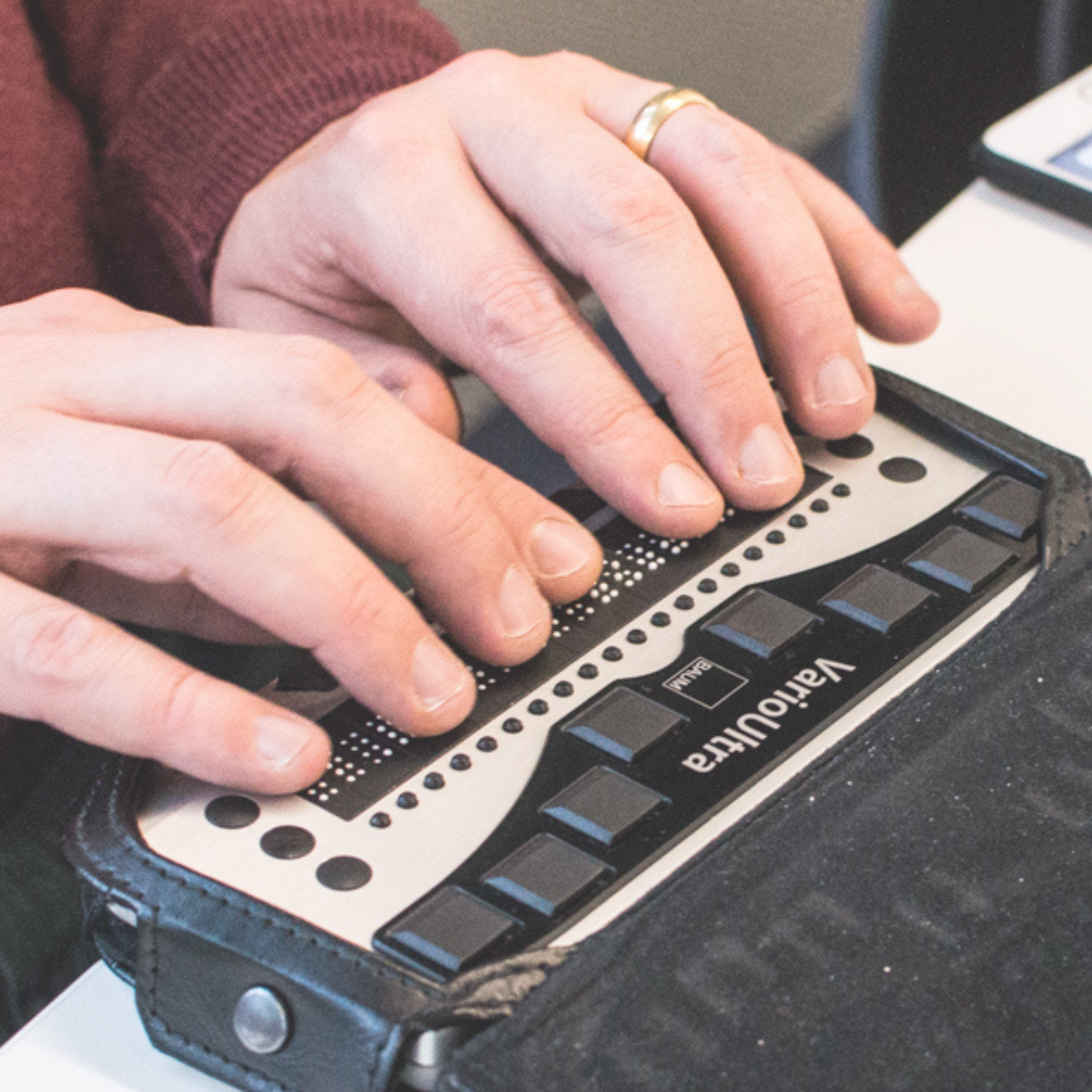 hands rested on a refreshable braille display
