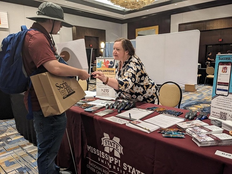 Karla talking to a visitor at the NRTC booth