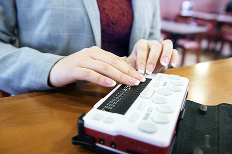 Individual using a braille reader.