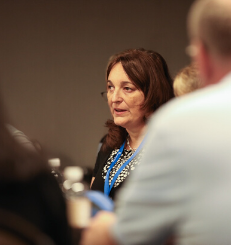 Sylvia Perez speaking at conference table discussion