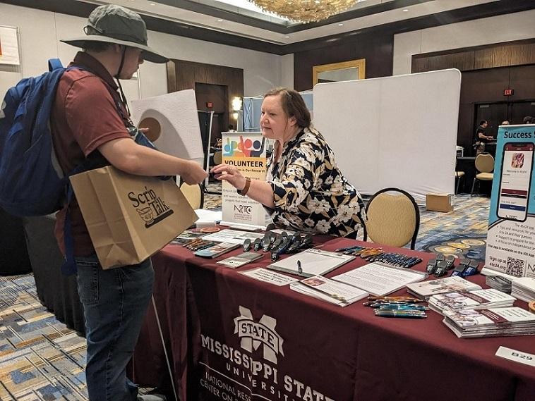 Karla talking to a visitor at the NRTC booth