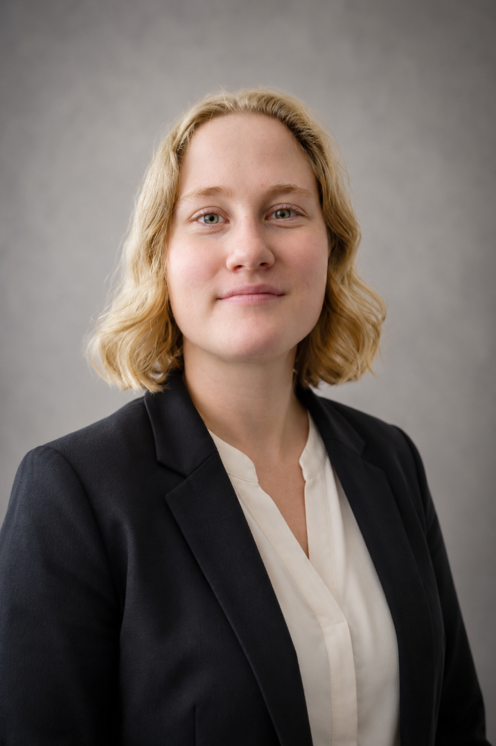 Headshot of Hayden. She is wearing a professional blazer and is smiling.